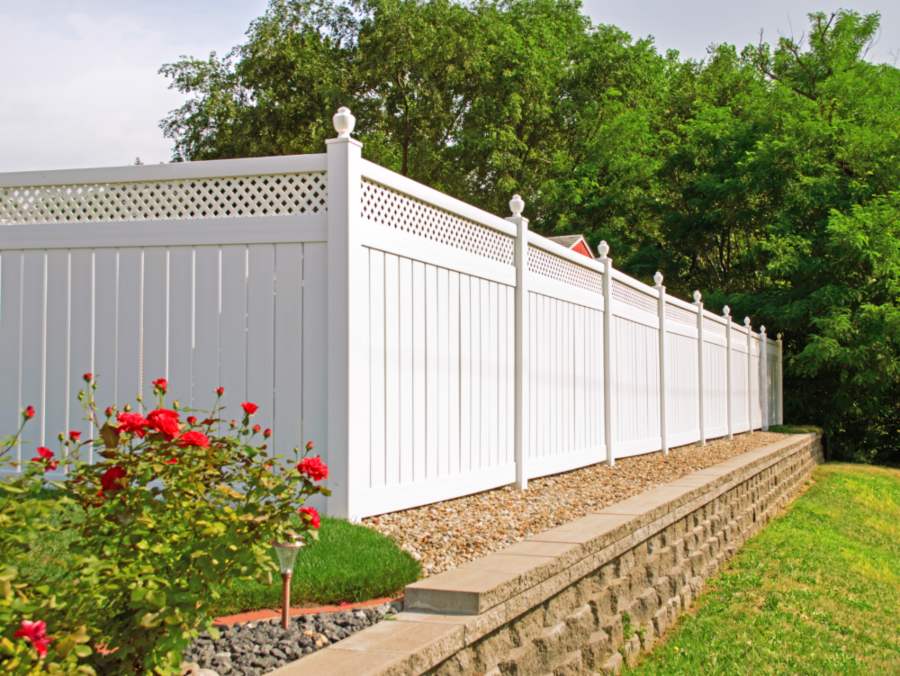 Beautiful white vinyl fence in back yard