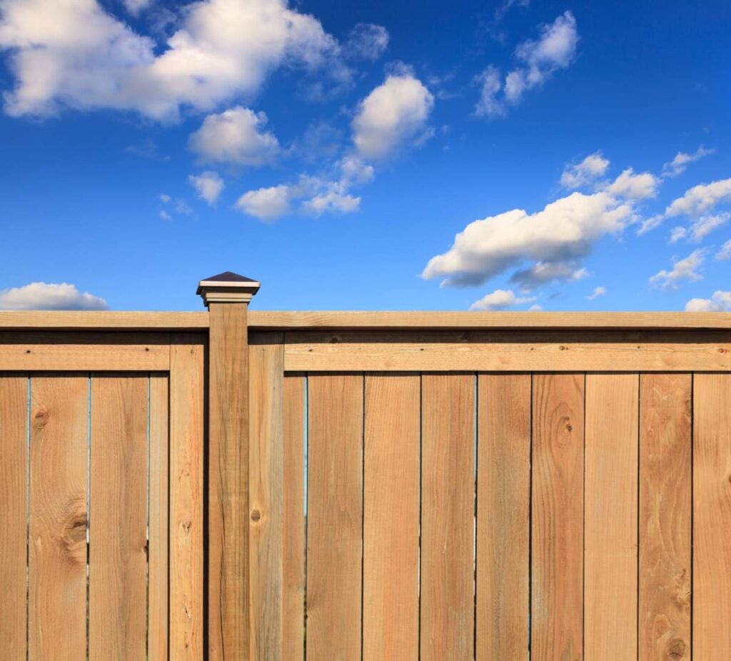 A new cedar fence with ornate posts